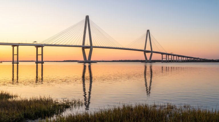 The Arthur Ravenel Jr. Bridge spanning the Cooper River at sunset, viewed from the Mount Pleasant shoreline