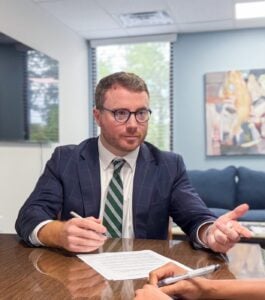 Attorney Taylor Grooms working at his desk at Grooms Law Firm in Charleston, SC