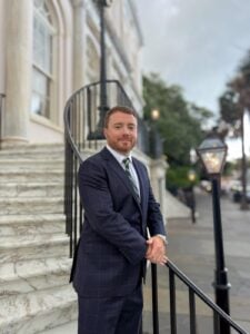 Taylor Grooms, Charleston personal injury attorney, outside a historic Charleston building