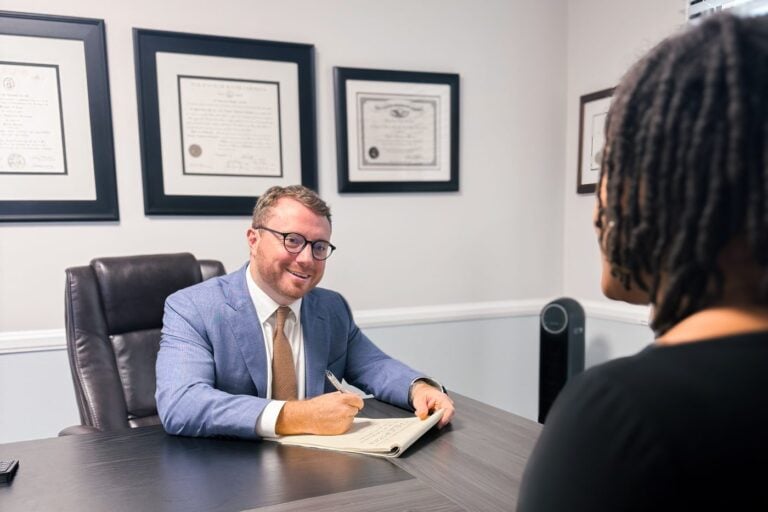 Charleston injury lawyer Taylor Grooms explaining an injury claim to a client