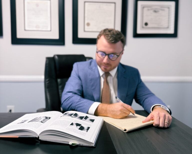 Taylor Grooms reviewing a personal injury case file at Grooms Law Firm in Charleston
